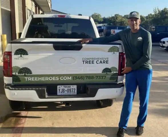 Tree Heroes crew member with the company truck